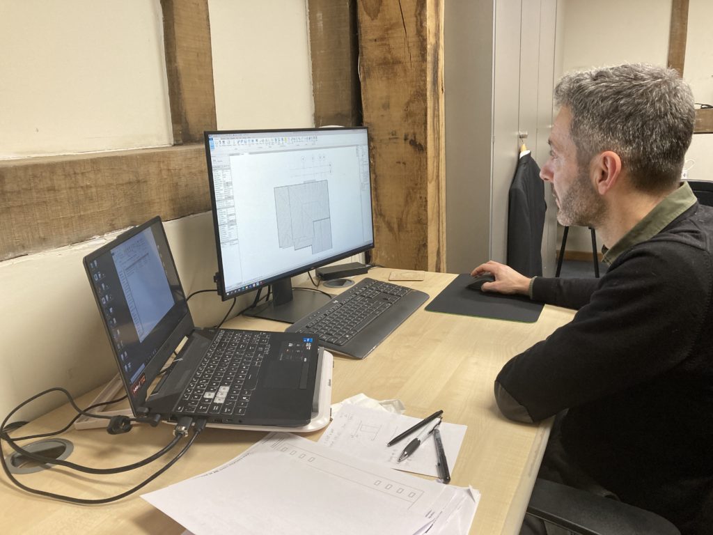 Architect sitting at computer in MB Architecture office